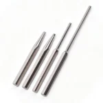 Four polished metal punches arranged on a white background, including two tapered punches and two long pin punches.